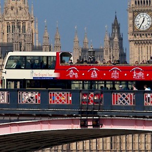 A hop-on/hop-off open-top double decker sightseeing bus crossing London Bridge (Photo Â© The Original London Sightseeing Tour Ltd 2016)