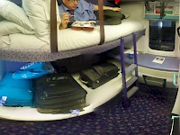 A wide angle shot of a Caledonian Sleeper twin berth cabin