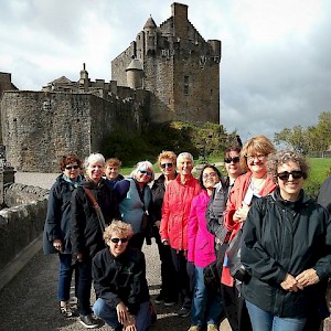 A Sights and Soul tour of Scotland in front of the 13C Eileen Donan castle (Photo courtesy of Sights and Soul)