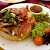 A rarebit is bread (in this case, a Sally Lunn bun) topped with a cheesy, mustardy, beery sauce. What makes this one special is the fried mushrooms and bacon on top., Sally Lunn’s, Bath (Photo by Su-Lin)