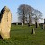 Going anti-clockwise around the Great Circle from the left: stone 12, a concrete pylon marking the position of stone 11, stone 10, stone 9 (The Barber Stone), stone 8, stone 7, stone 6, stone 5 and stone 4. The trees in the background are at the southern entrance to Avebury henge., Avebury, Salisbury and Stonehenge (Photo by Jim Champion)